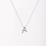 Letter silhouette necklace.