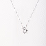 Letter silhouette necklace.