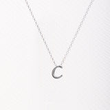 Letter silhouette necklace.