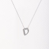 Letter silhouette necklace.