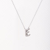 Letter silhouette necklace.