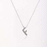 Letter silhouette necklace.