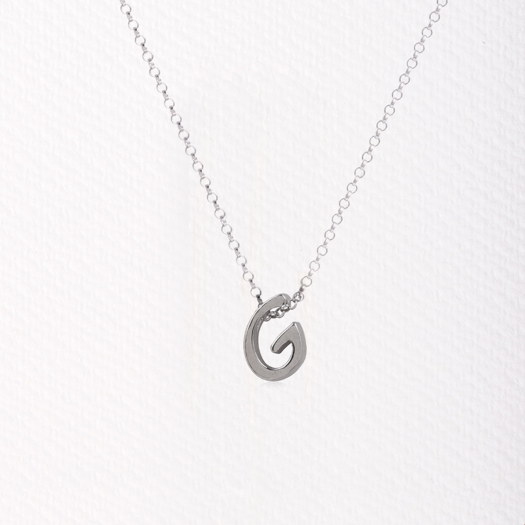 Letter silhouette necklace.