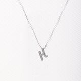 Letter silhouette necklace.