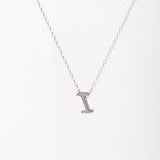 Letter silhouette necklace.