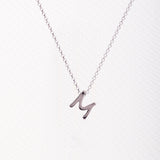 Letter silhouette necklace.