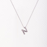 Letter silhouette necklace.